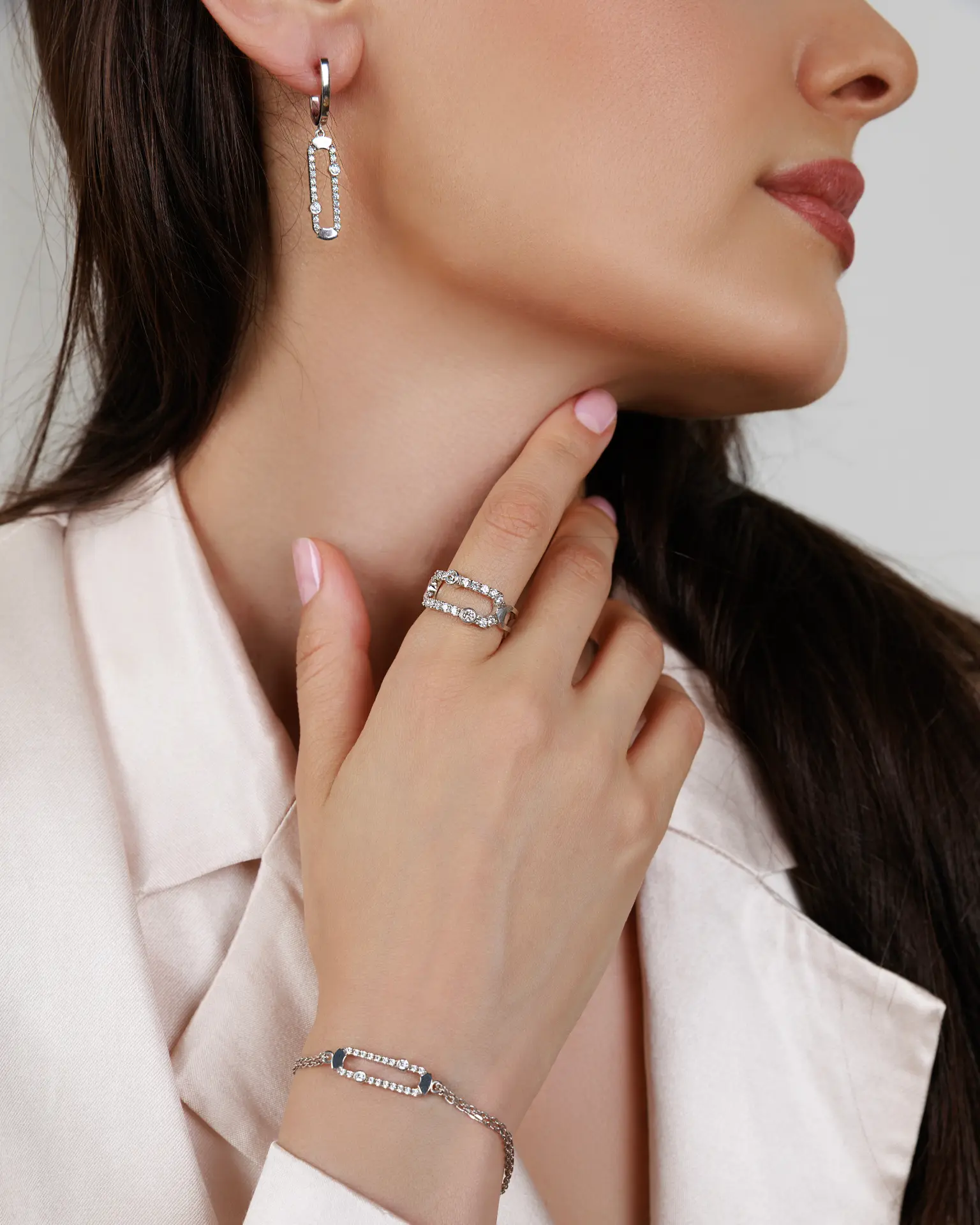 Model wearing the diamond link earring, ring and bracelet